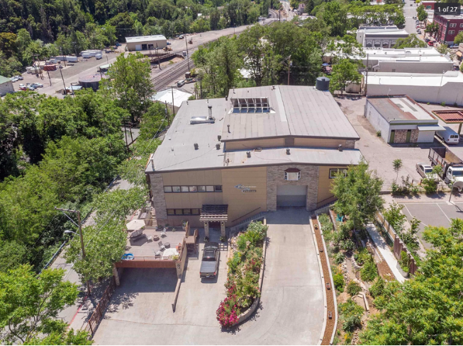 The campus building from above, with its driveway and gardens and the town beyond
