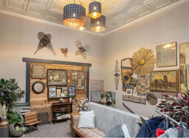 The front sitting room, with its pressed-tin ceiling and gathered wall of pictures